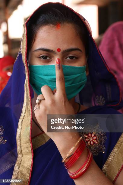 An Hindu Women shows her finger after casting her vote outside a polling station during the 5th phase of West Bengal's state legislative assembly...