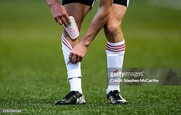 Derry , United Kingdom - 16 April 2021; A player puts a shin pad back into his sock during the SSE Airtricity League Premier Division match between...