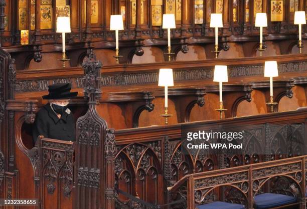 Queen Elizabeth II takes her seat during the funeral of Prince Philip, Duke of Edinburgh, at St George's Chapel at Windsor Castle on April 17, 2021...