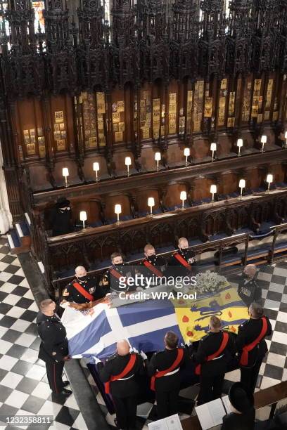 Queen Elizabeth II watches as the coffin of Prince Philip, Duke of Edinburgh, is placed during his funeral at St George's Chapel at Windsor Castle on...