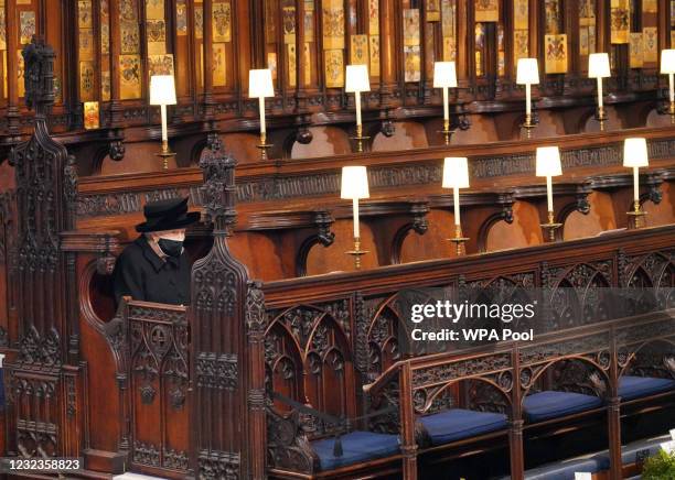 Queen Elizabeth II takes her seat during the funeral of Prince Philip, Duke of Edinburgh, at St George's Chapel at Windsor Castle on April 17, 2021...