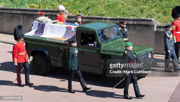 The purpose built Land Rover carrying Prince Philip, Duke of Edinburgh's coffin is flanked by pallbearers from the Royal Marines and other regiments...