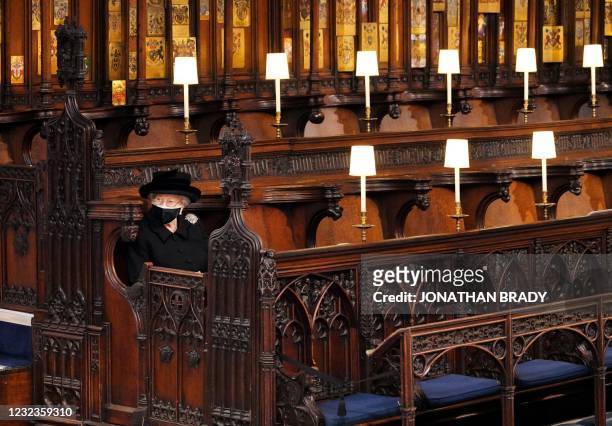 Queen Elizabeth II takes her seat for the funeral service of Britain's Prince Philip, Duke of Edinburgh inside St George's Chapel in Windsor Castle...