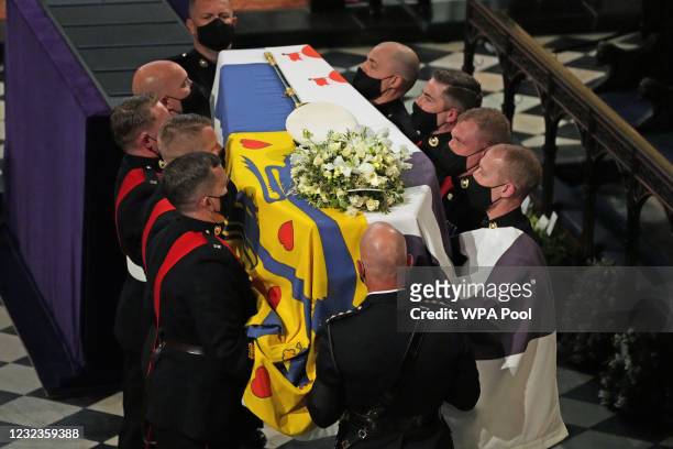 The Duke of Edinburgh’s coffin, covered with His Royal Highness’s Personal Standard is carried into St George’s Chapel by the pallbearers during the...