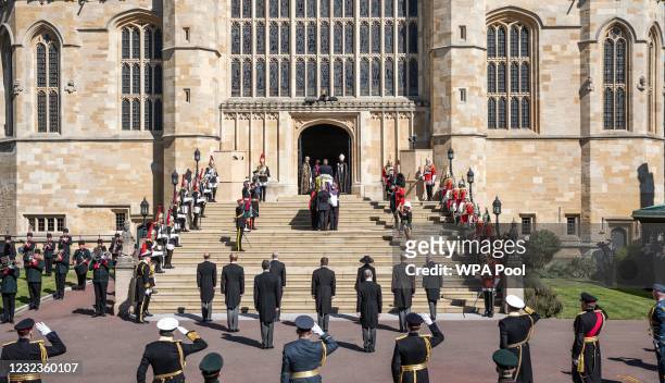 Members of the royal family watch as Prince Philip, Duke of Edinburgh’s coffin, covered with His Royal Highness’s Personal Standard arrives at St...
