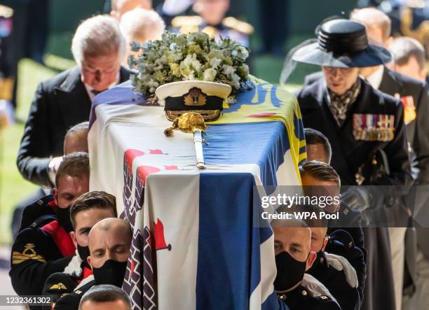 Princess Anne, Princess Royal and Prince Charles, Prince of Wales follow the coffin of Prince Philip, Duke of Edinburgh, as it is carried into his...