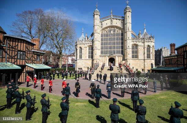 Members of the royal family watch as Prince Philip, Duke of Edinburgh’s coffin, covered with His Royal Highness’s Personal Standard arrives at St...