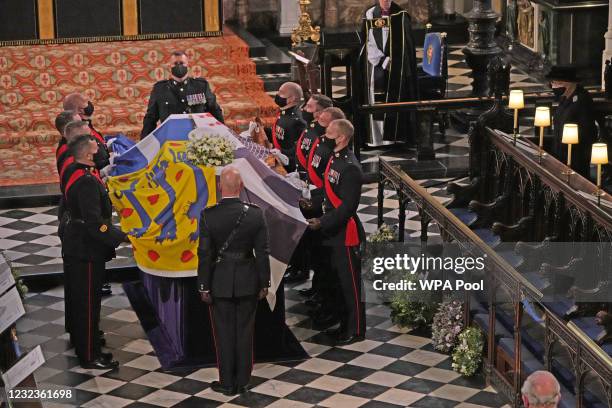 The Duke of Edinburgh’s coffin, covered with His Royal Highness’s Personal Standard is displayed in St George’s Chapel as Queen Elizabeth II watches...