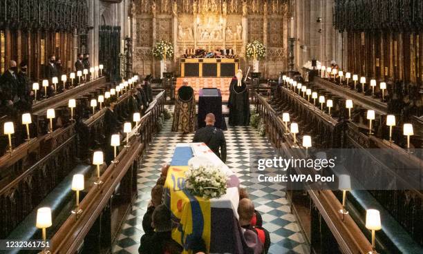 The Duke of Edinburgh’s coffin, covered with His Royal Highness’s Personal Standard is carried into The Quire in St George’s Chapel by the...