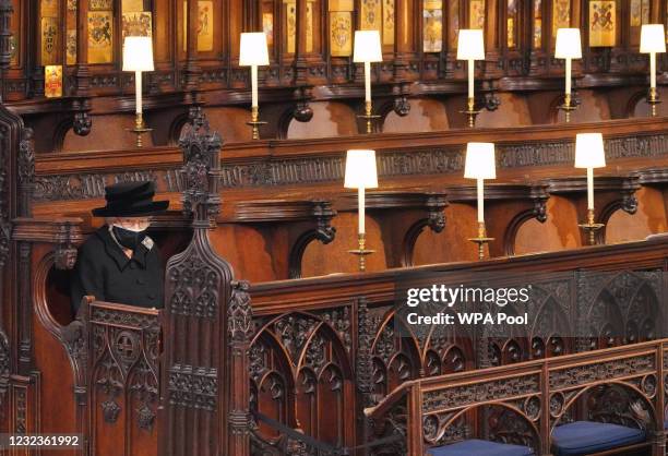 Queen Elizabeth II takes her seat during the funeral of Prince Philip, Duke of Edinburgh in St George's Chapel at Windsor Castle on April 17, 2021 in...