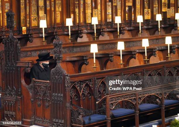 Queen Elizabeth II takes her seat during the funeral of Prince Philip, Duke of Edinburgh, at St George's Chapel at Windsor Castle on April 17, 2021...