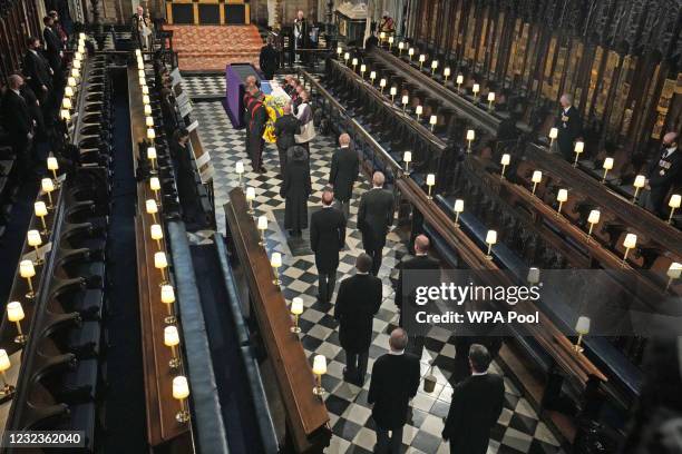 The Duke of Edinburgh’s coffin, covered with His Royal Highness’s Personal Standard is carried into St George’s Chapel by the pallbearers during the...