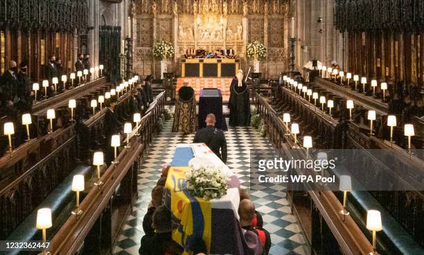 The Duke of Edinburgh’s coffin, covered with His Royal Highness’s Personal Standard is carried into The Quire in St George’s Chapel by the...