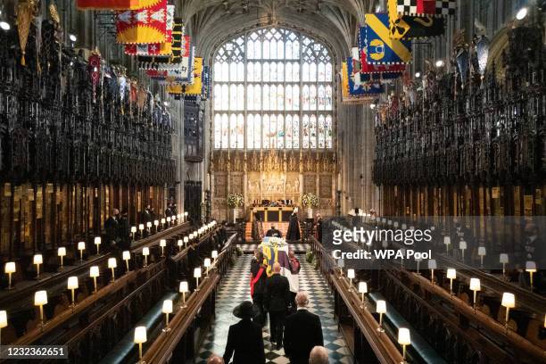 The Duke of Edinburgh’s coffin, covered with His Royal Highness’s Personal Standard is carried into The Quire in St George’s Chapel by the...