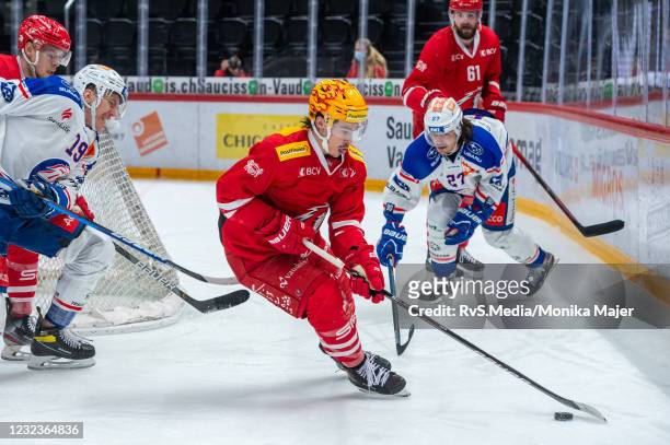 Charles Hudon of Lausanne HC battles for the puck with Reto Schappi of ZSC Lions during the Swiss National League Playoff game at Vaudoise Arena on...