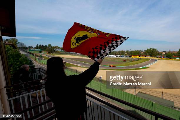 Local residents watch the Formula One cars pass by their homes during practice ahead of the Grand Prix of Emilia Romagna at Autodromo Enzo e Dino...