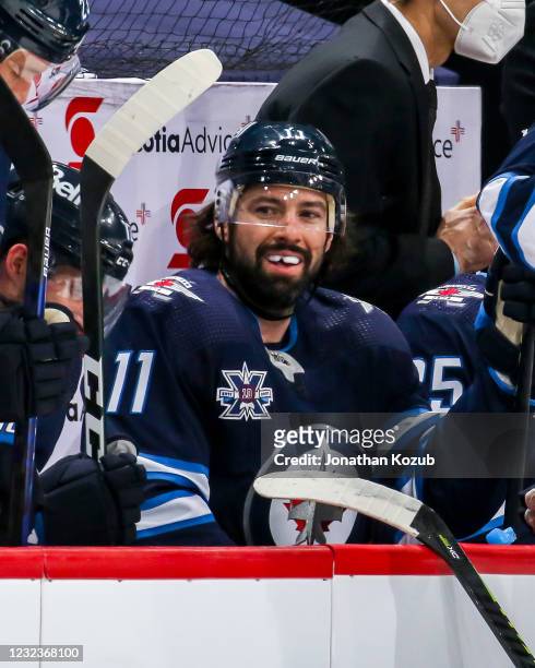 Nate Thompson of the Winnipeg Jets is all smiles at the bench during a first period stoppage in play against the Edmonton Oilers at the Bell MTS...