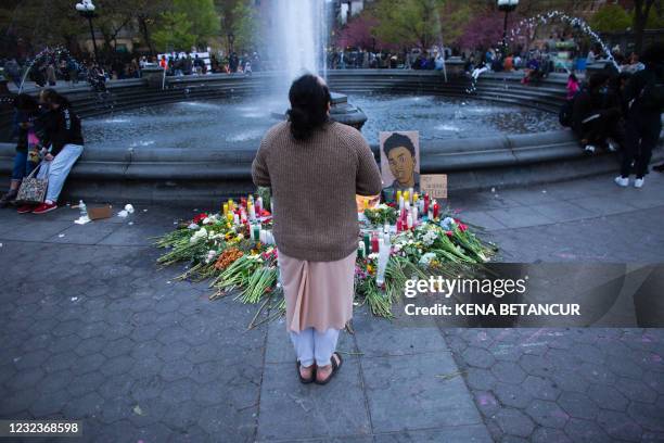 Person stands in front of a makeshift memorial in honor of Daunte Wright, who was shot dead by a police officer in Minneapolis, in Washington Square,...