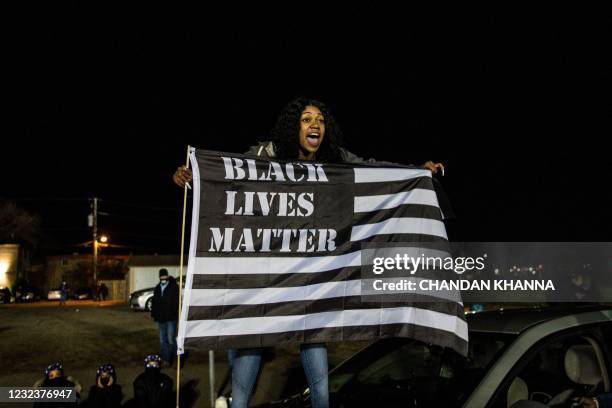 Demonstrator shouts slogans as they gather during the seventh night of protests over the shooting death of Daunte Wright by a police officer in...