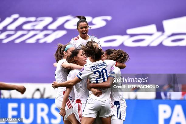 Lyon's players celebrate after Lyons US midfielder Catarina Macario scored a goal during the UEFA Womens Champions League quarter final football...