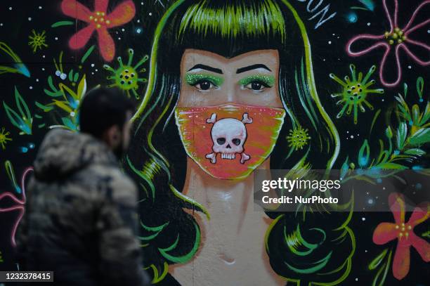 Man walks past a mural by Mr. Gabriel Marques seen in Dublin's Grand Canal area, during COVID-19 lockdown. On Sunday, 18 April 2021, in Dublin,...