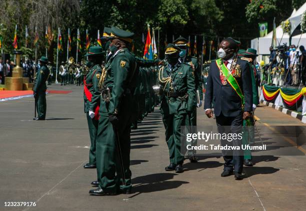 Zimbabwe's president Emmerson Mnangagwa inspects the guard of honour during the Independence Celebrations on April 18, 2021 in Harare, Zimbabwe....