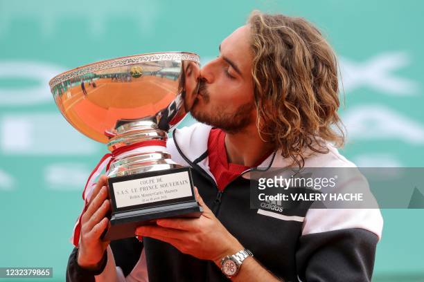 Greece's Stefanos Tsitsipas poses for pictures with the trophy after winning the final singles match against Russia's Andrey Rublev on day nine of...