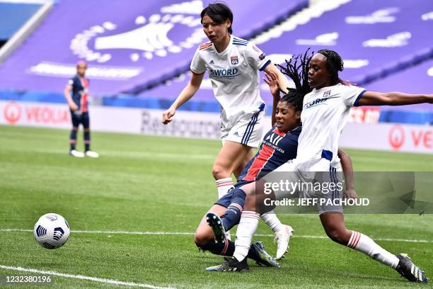 Paris Saint-Germains Canadian defender Ashley Lawrence fights for the ball with Lyons Japanese midfielder Saki Kumagai and Lyons French forward...