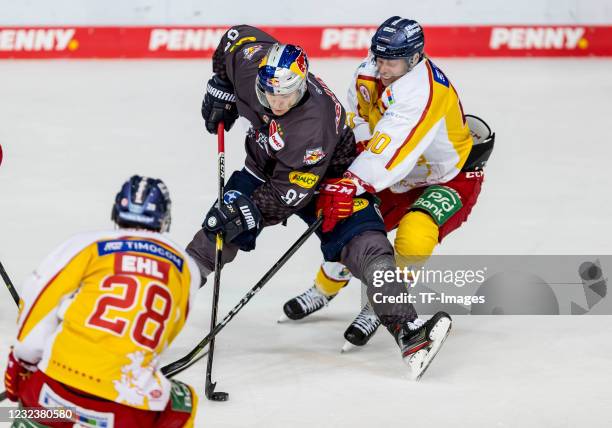 Philip Gogulla of EHC Red Bull Muenchen and Ken Andre Olimb of Duesseldorfer EG battle for the Puck the Penny DEL match between EHC Red Bull München...