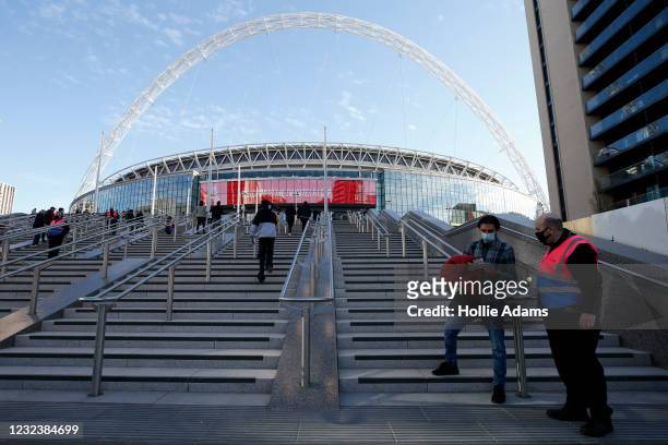 Football fans enter Wembley Stadium on April 18, 2021 in London, England. 4000 local residents have been permitted to attend the Leicester City vs...