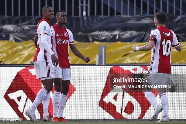 Ajax's Dutch forward Sebastien Haller and Serbian forward Dusan Tadic celebrate a goal by Dutch midfielder Ryan Gravenberch during the Toto KNVB cup...