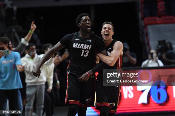 Bam Adebayo and Duncan Robinson of the Miami Heat react after the game winning shot against the Brooklyn Nets on April 18, 2021 at American Airlines...