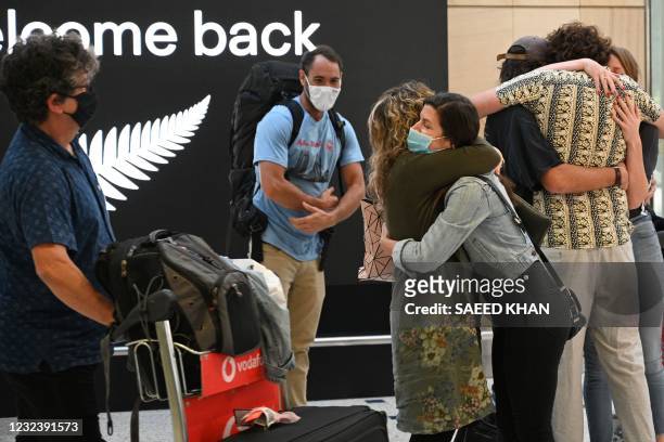 Family members embrace each other upon their arrival from New Zealand at Sydney International Airport on April 19 as Australia and New Zealand opened...