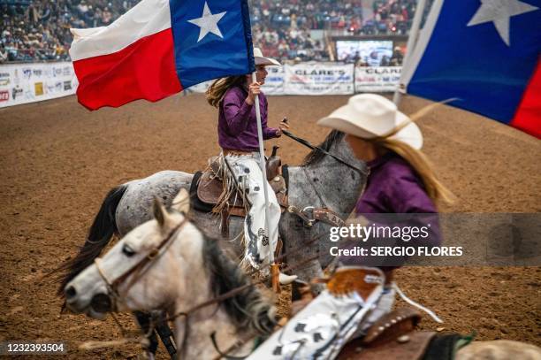 Riders carry the Texas state flag during the opening ceremony of the San Angelo Stock Show and Rodeo, April 16, 2021 in San Angelo, Texas. - The...