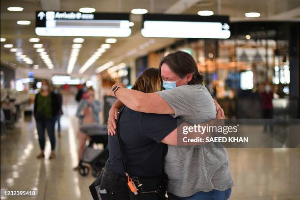 Mother embraces her daughter upon her arrival from New Zealand at Sydney International Airport on April 19 as Australia and New Zealand opened a...