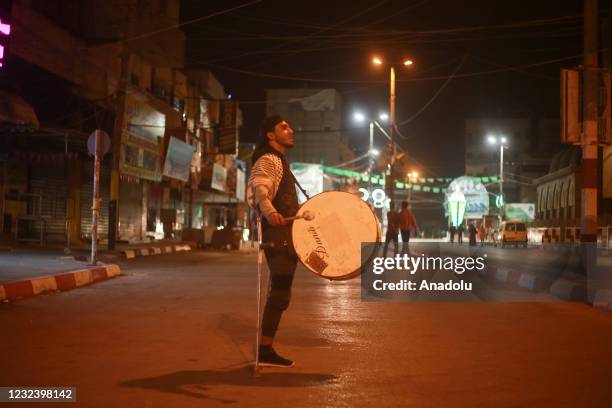 Palestinian Ramadan drummer Heysem Nasser is seen playing drum to wake people up for sahur meal on a street during the holy month of Ramadan, on...