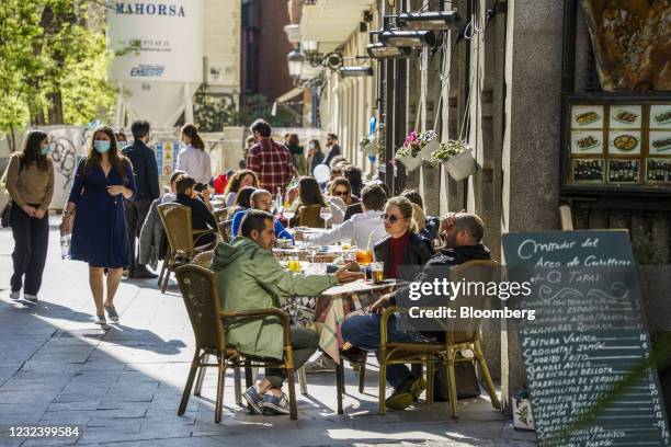 Customers at tables outside a tapas bar in Madrid, Spain, on Saturday, April 17, 2021. European travel and leisure stocks have gained 20% this year...