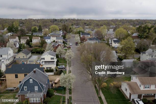 Residential homes in Manhasset, New York, U.S., on Friday, April 16, 2021. Across the U.S., house hunters are fighting for scraps in a market picked...