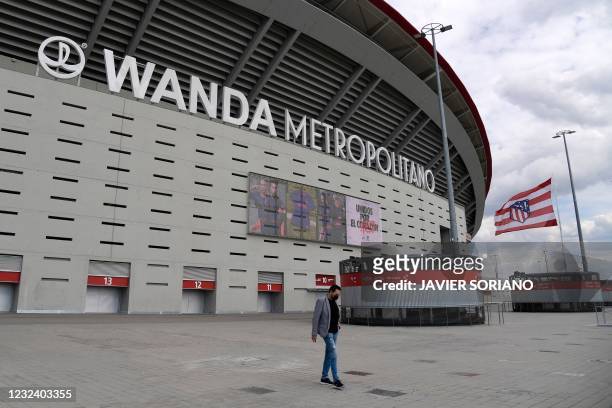 Man walks outside Spanish football club Atletico Madrid's Wanda Metropolitano stadium in Madrid on April 19, 2021. - Plans for a breakaway Super...