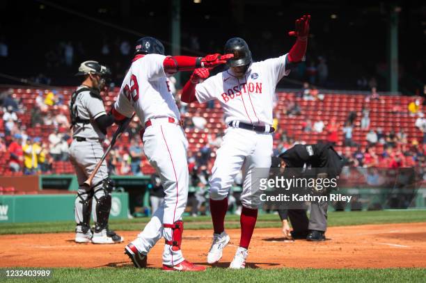 Kiké Hernandez celebrates with teammate Alex Verdugo of the Boston Red Sox after hitting a solo home run in the first inning against the Chicago...