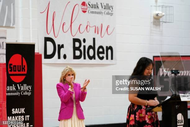 First lady Jill Biden, left, applauds after being introduced to speak by SVCC student Abril Vasquez-Tapia, right, during a visit to Sauk Valley...