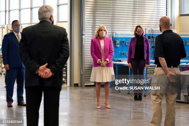 First lady Jill Biden, center, Education Secretary Miguel Cardona, left and Rep. Cheri Bustos, D-Ill., second from right, tour the Sauk Valley...