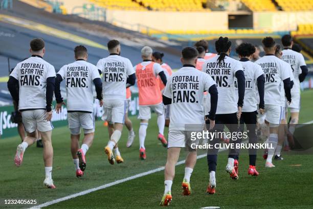Leeds United players wear T-shirts with slogans against a proposed new European Super League during the warm up for the English Premier League...