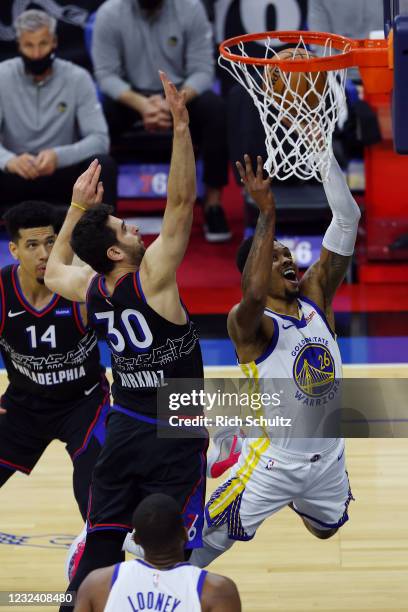 Kent Bazemore of the Golden State Warriors goes up for a shot as Furkan Korkmaz of the Philadelphia 76ers defends during the first period at Wells...