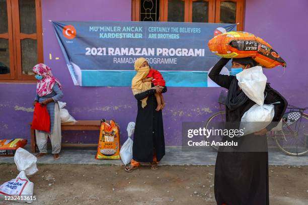 Nepalese receive food packages delivered by Turkey' Diyanet Foundation during the holy month of Ramadan in Nepalgunj, Nepal on April 19, 2021.