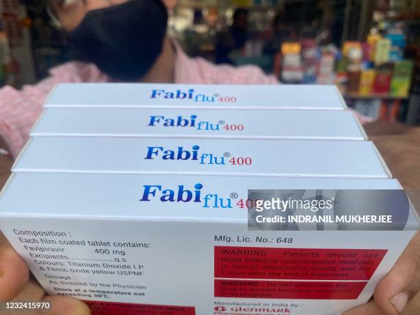 Staff member sorts Fabiflu tablets, an anti-viral medicine containing favipiravir and used to treat mild to moderate Covid-19 cases, at a chemist in...