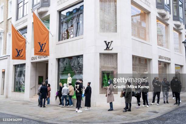Shoppers queue outside Louis Vuitton as they return to the exclusive shopping area on Bond Street as non-essential shops reopen and the national...