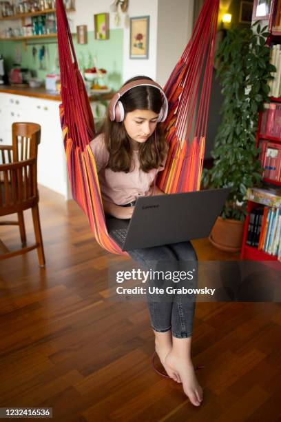 Bonn, Germany In this photo illustration a girl sits in a hammock seat and doing her homework on April 16, 2021 in Bonn, Germany.