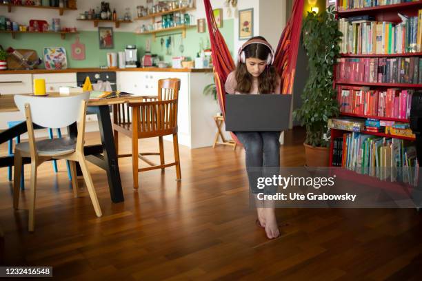 Bonn, Germany In this photo illustration a girl sits in a hammock seat and doing her homework on April 16, 2021 in Bonn, Germany.