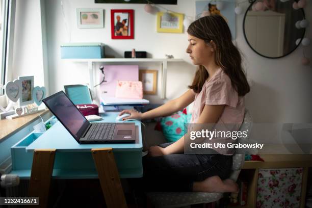 Bonn, Germany In this photo illustration a girl sits at a desk, doing her work at a laptop on April 16, 2021 in Bonn, Germany.